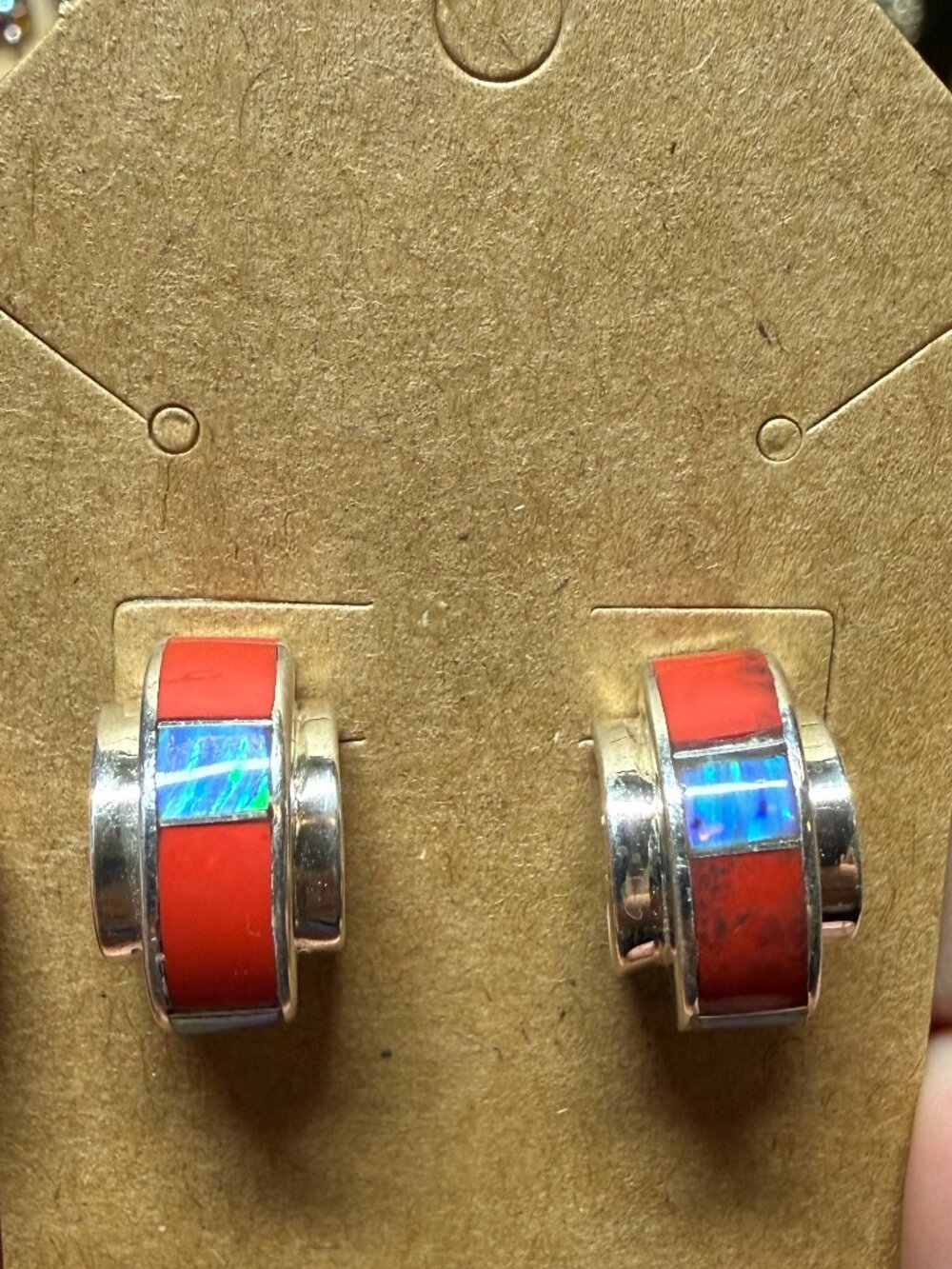 Sterling silver half hoop earrings feature a distinctive channel inlay.
